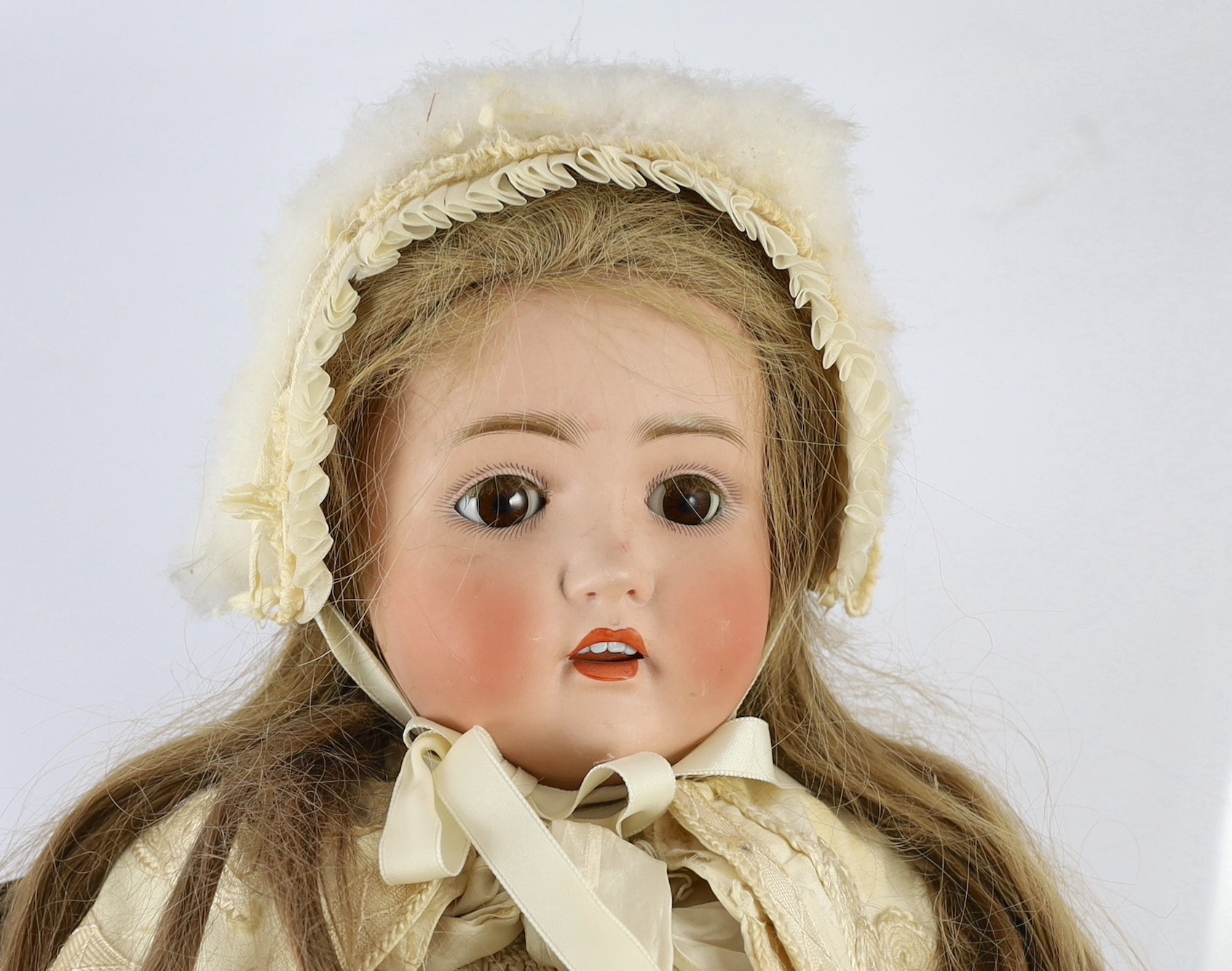 A J.D. Kestner large bisque doll, German, circa 1916, 31in. Please note the chair is for display purposes only.